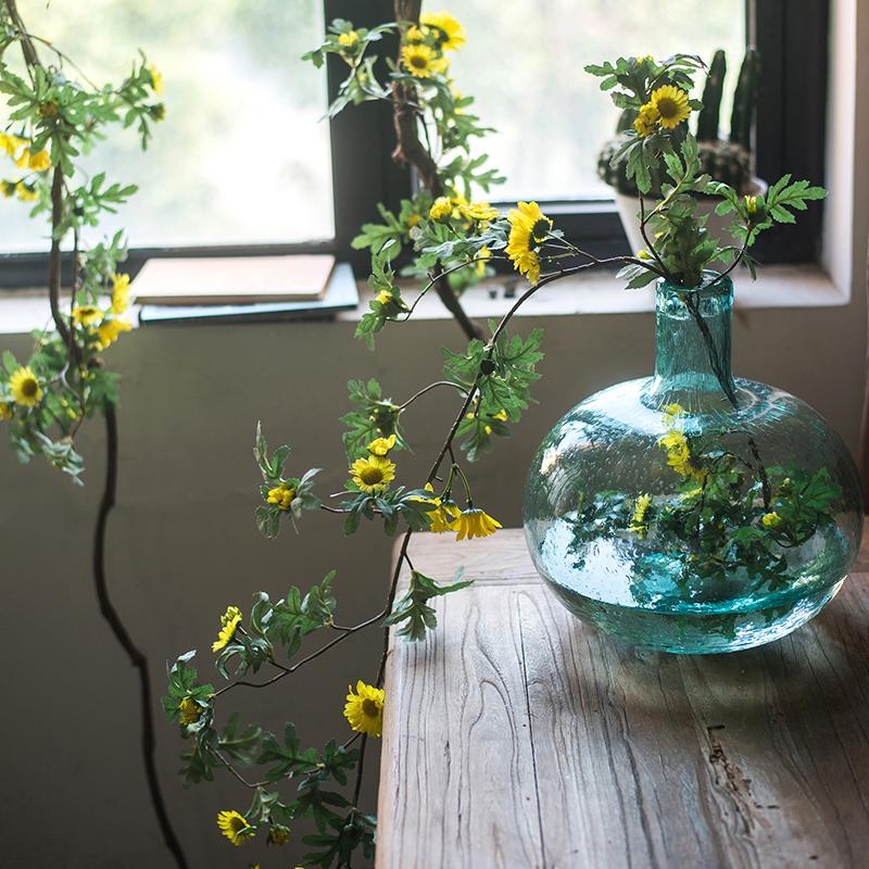 A long artificial sunflower vine featuring vibrant yellow sunflowers and lush green leaves, perfect for home decor.