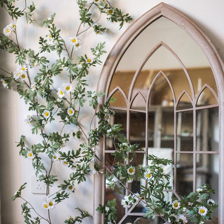 A long 67-inch artificial sunflower vine featuring vibrant yellow sunflowers and lush green leaves, perfect for home decor.