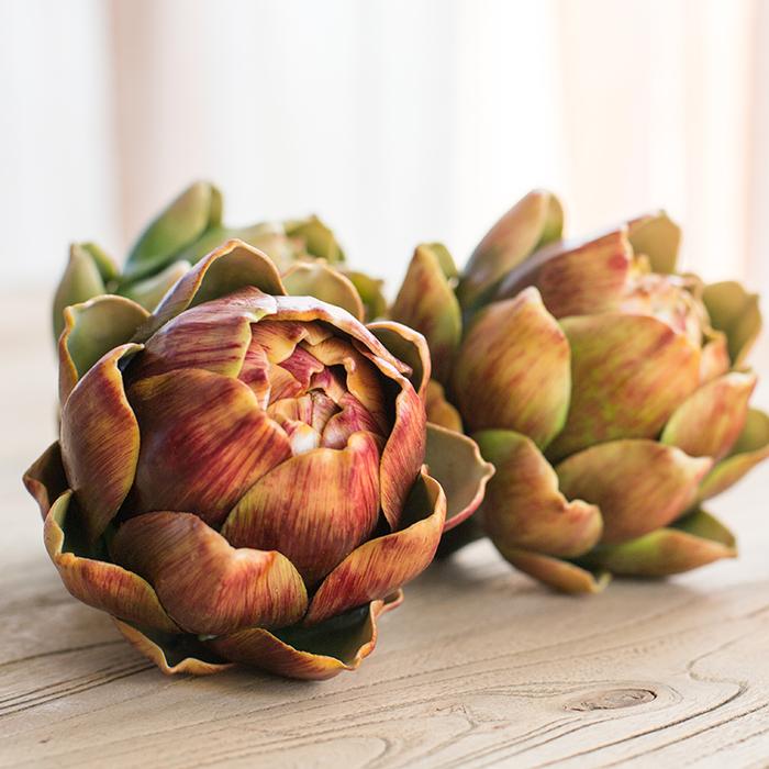 Set of 3 realistic artificial artichokes in vibrant colors, showcasing their lifelike texture and detail.