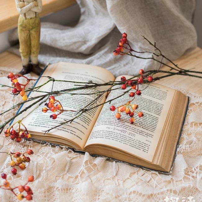 A 39-inch long artificial vine featuring vibrant orange faux berries and brown accents, perfect for home decor.