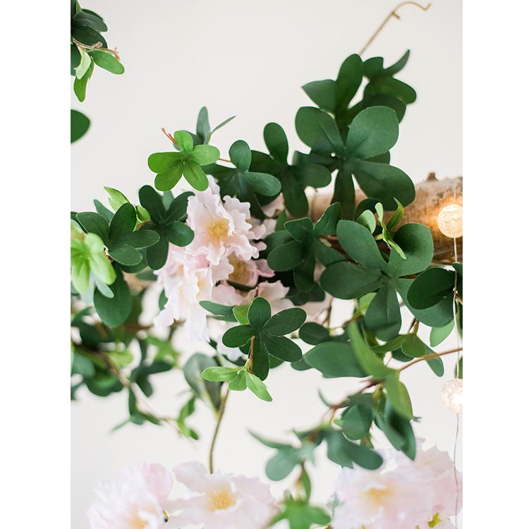 Artificial Vine Schefflera Leaf in vibrant green, showcasing realistic silk leaves and a long, hanging design for decorative use.