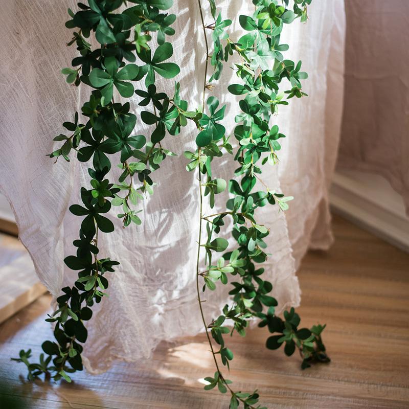 Artificial Vine Schefflera Leaf in vibrant green, showcasing realistic silk leaves and a long, hanging design for decorative use.