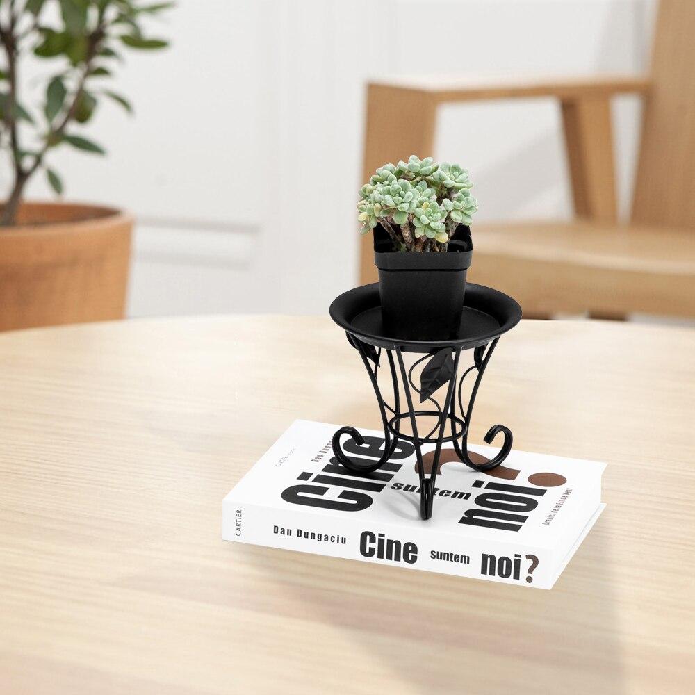 Artisasset 5.3Inch Plate Mini Paint Iron Plant Stand in black, showcasing a potted plant elegantly on a compact metal frame.