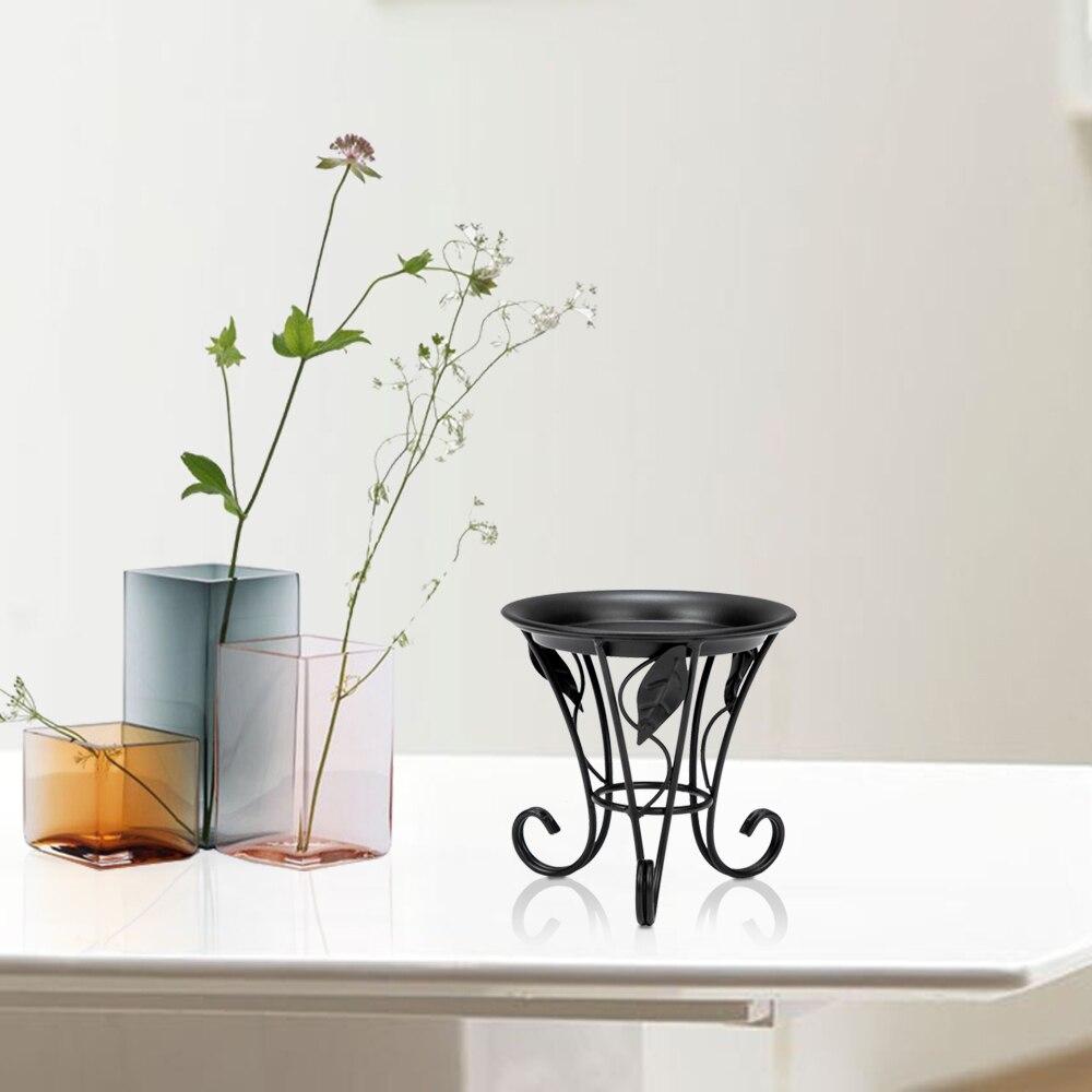 Artisasset 5.3Inch Plate Mini Paint Iron Plant Stand in black, showcasing a potted plant elegantly on a compact metal frame.