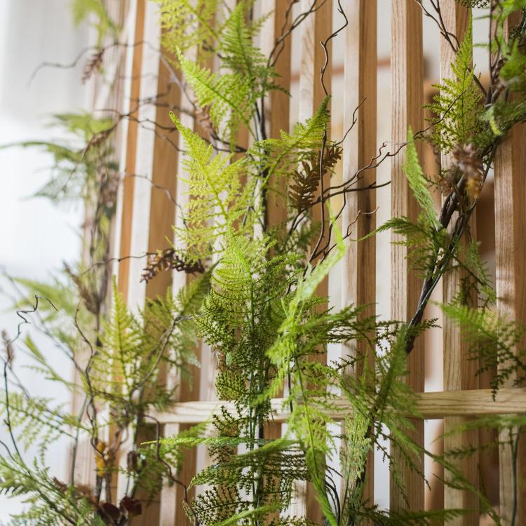 A 51-inch long artificial Asparagus Fern Vine with lush green leaves, perfect for home or office decor.