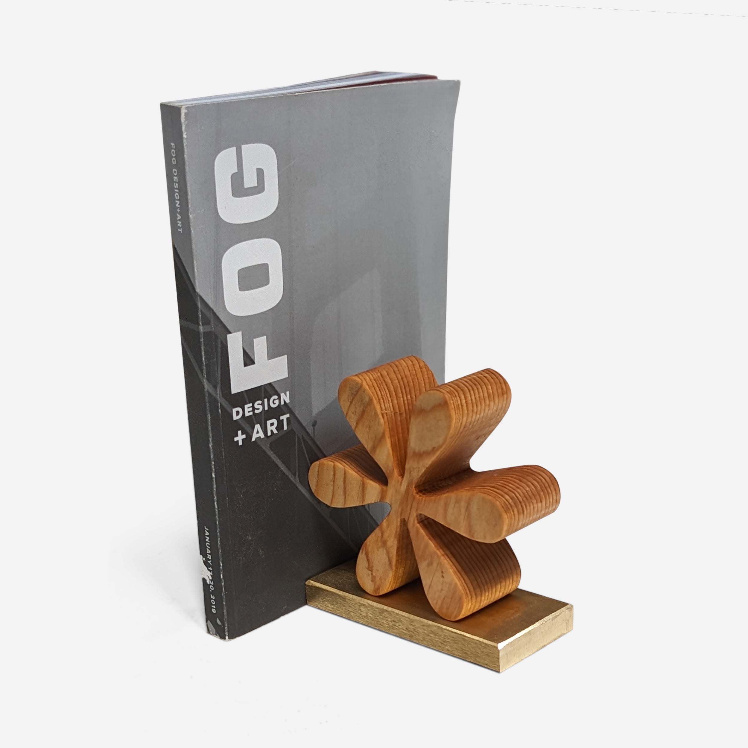 Asterisk bookends made of reclaimed wood with a natural finish, showcasing unique color variations and elegant brass accents.