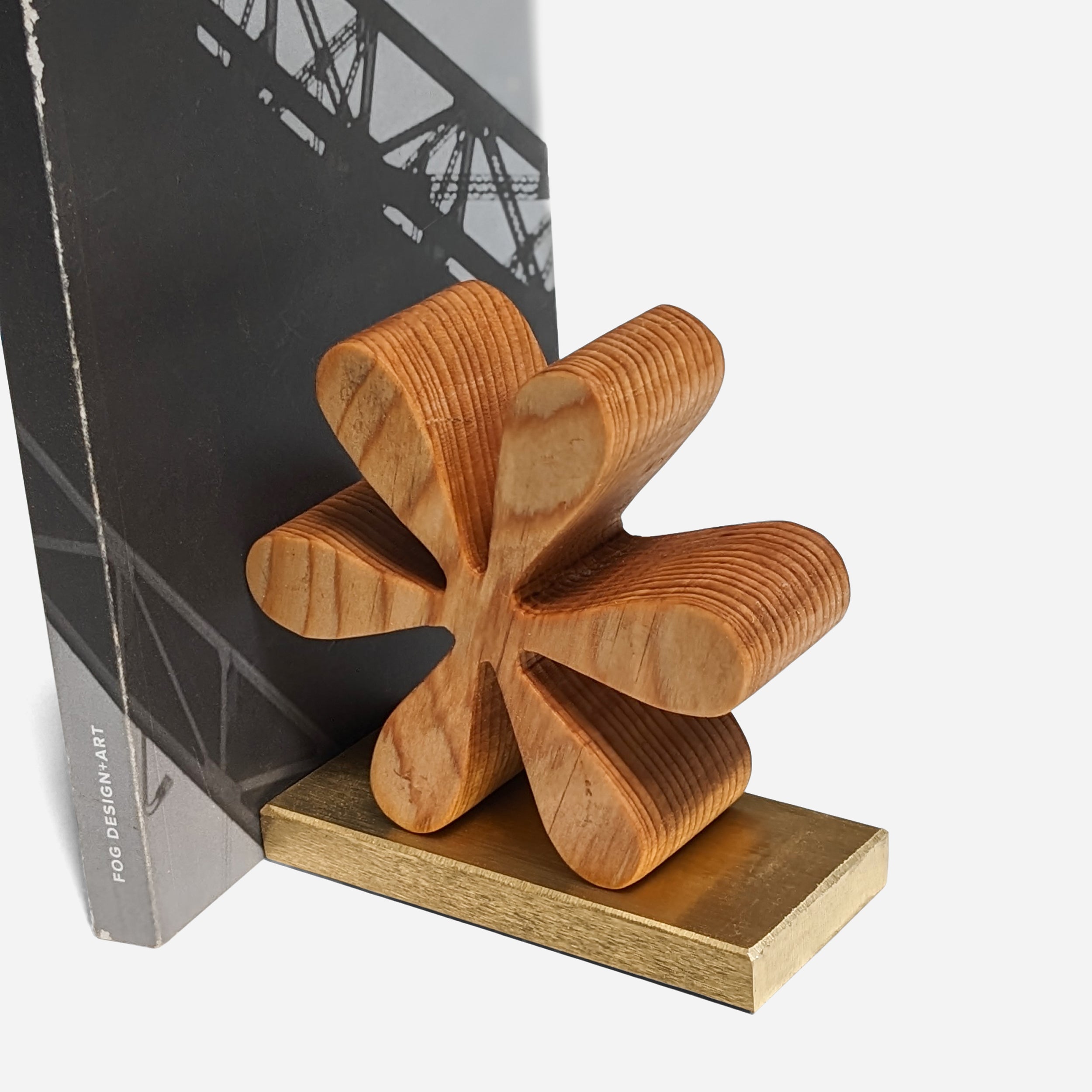 Asterisk bookends made of reclaimed wood with a natural finish, showcasing unique color variations and elegant brass accents.