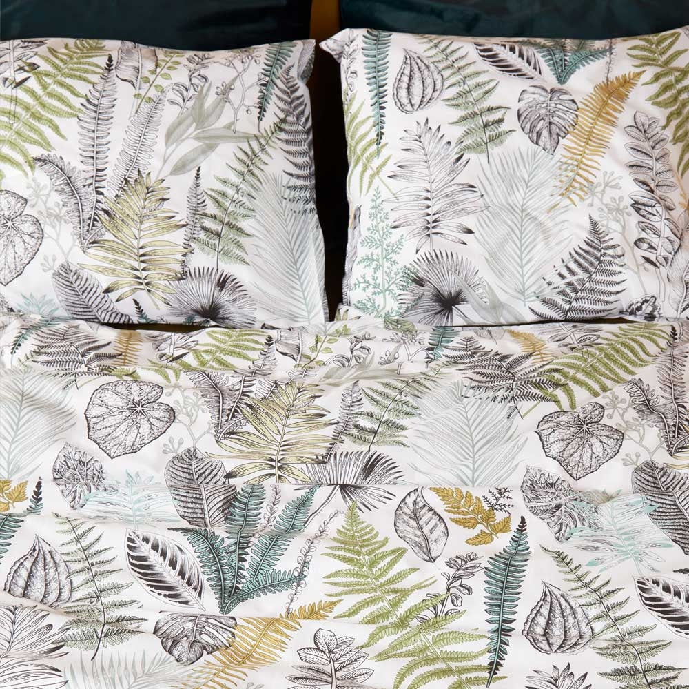 At Home Primeval Green Quilt Cover Set King featuring a botanical design in soothing colors of green, grey, and white, made from soft cotton sateen fabric.