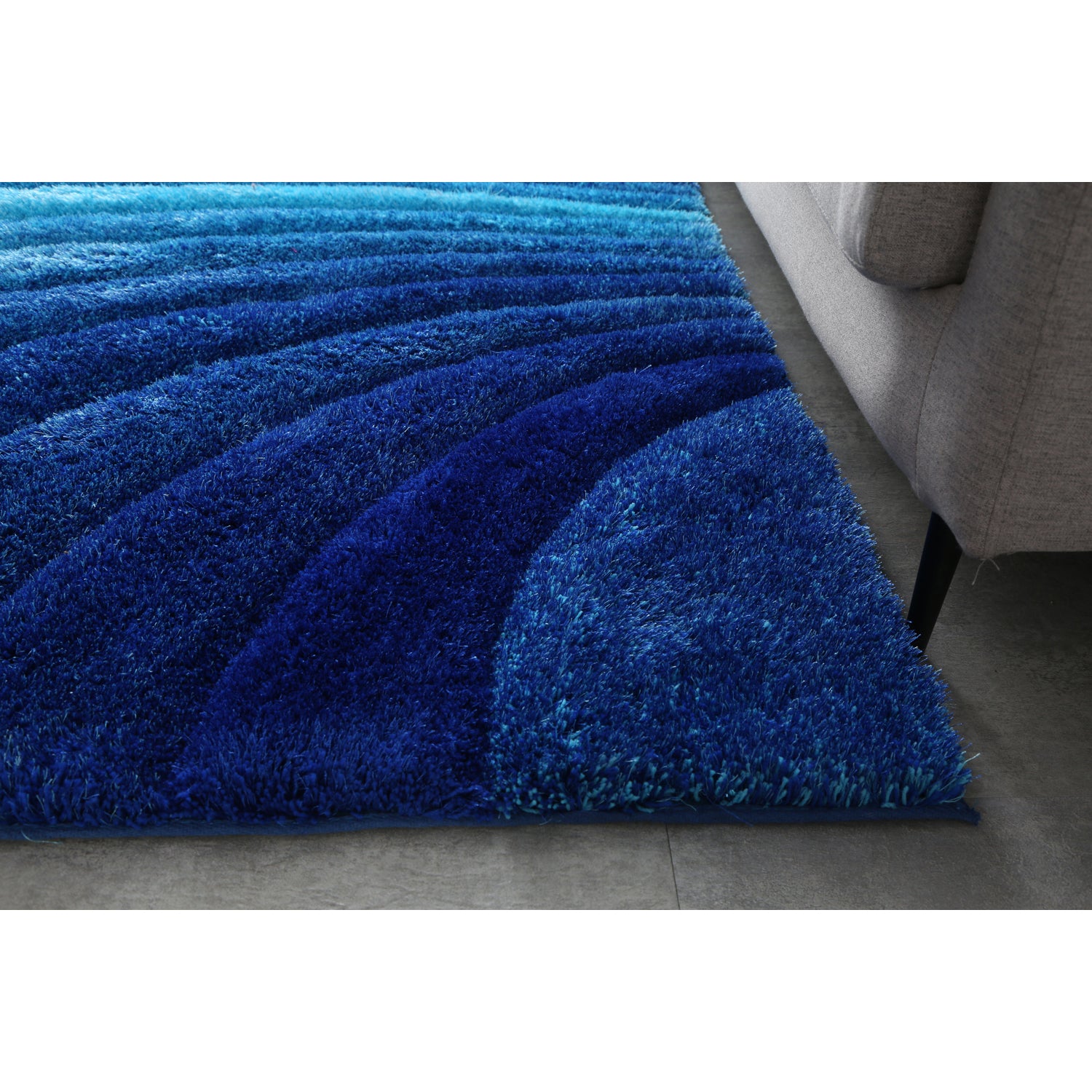 Aurora 3D Blue Shag Rug with modern wave design, showcasing vibrant blue colors and plush texture, perfect for any room.