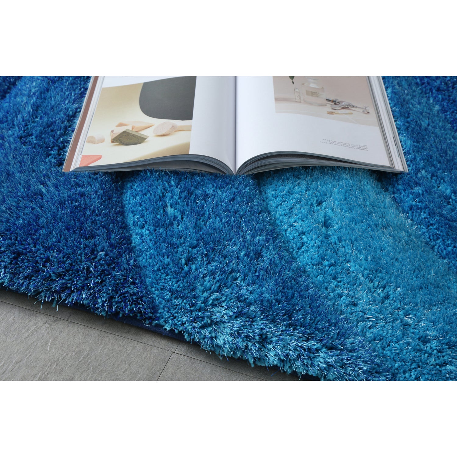 Aurora 3D Blue Shag Rug with modern wave design, showcasing vibrant blue colors and plush texture, perfect for any room.