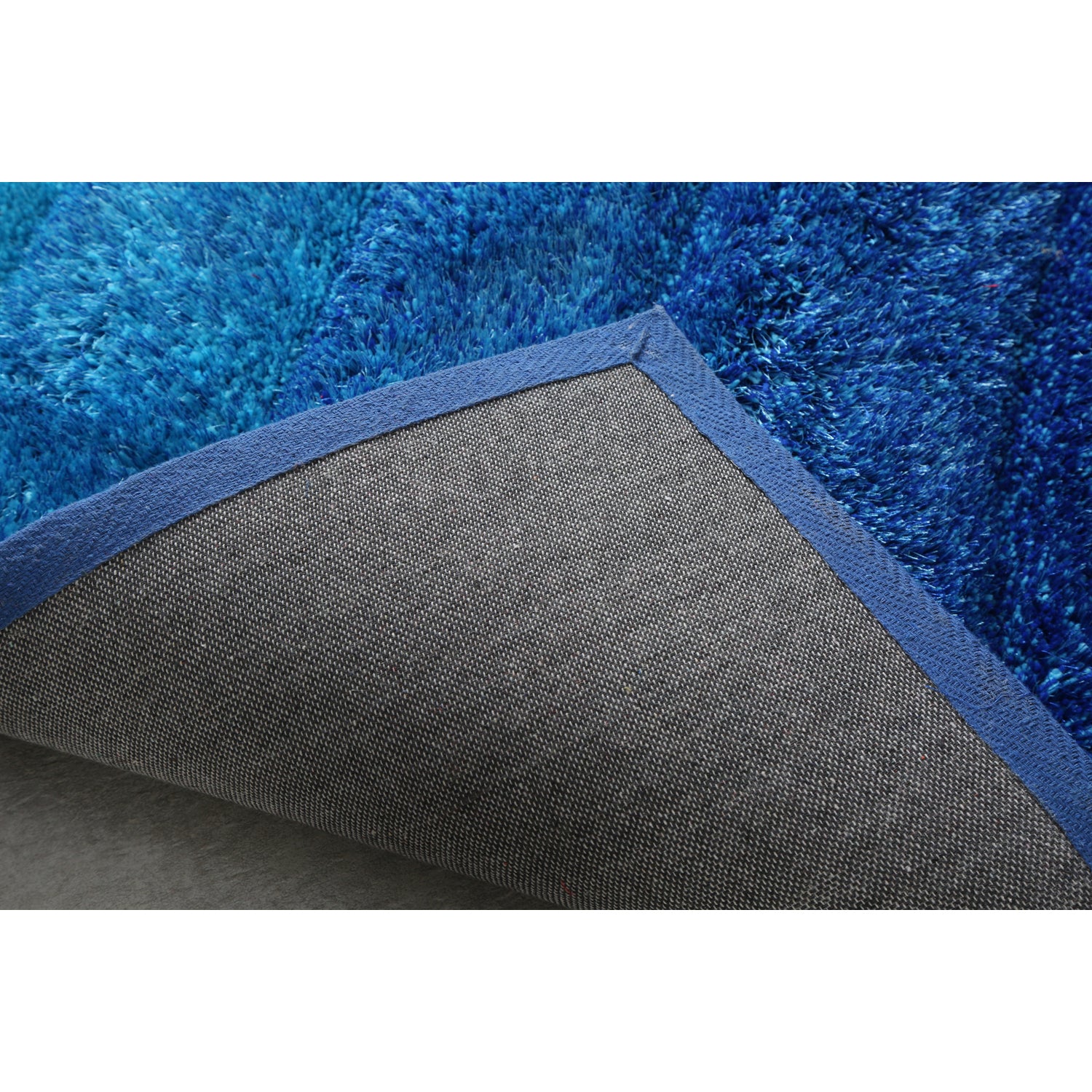 Aurora 3D Blue Shag Rug with modern wave design, showcasing vibrant blue colors and plush texture, perfect for any room.