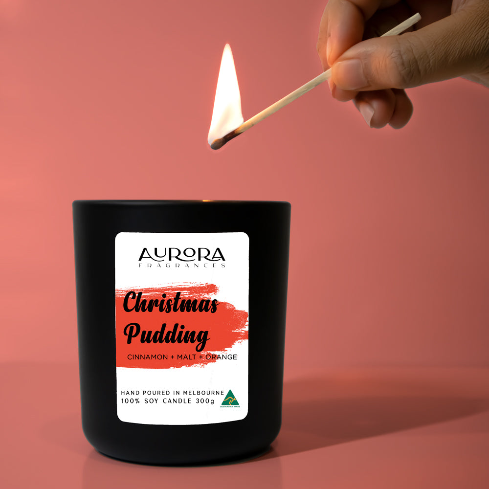 Aurora Christmas Pudding Scented Soy Candle in a matte black jar, showcasing its elegant design and festive appeal.