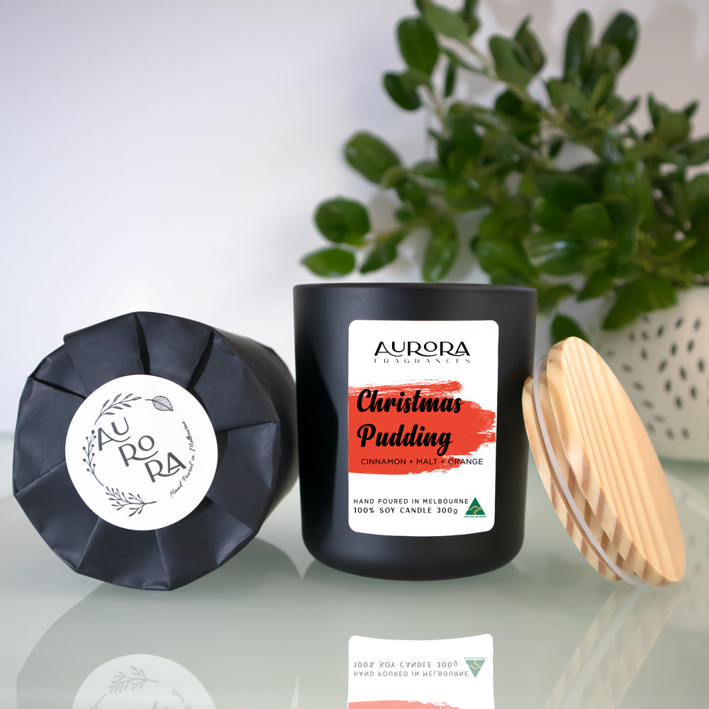 Aurora Christmas Pudding Scented Soy Candle in a matte black jar, showcasing its elegant design and festive appeal.