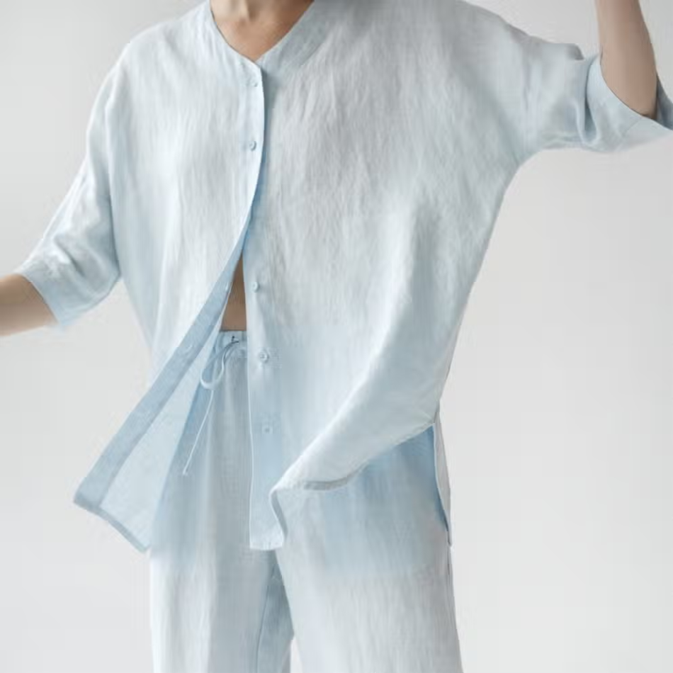 A stylish baby blue linen loungewear set featuring a loose-fit shirt and comfortable pants, perfect for relaxation and casual wear.