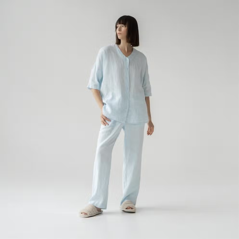 A stylish baby blue linen loungewear set featuring a loose-fit shirt and comfortable pants, perfect for relaxation and casual wear.