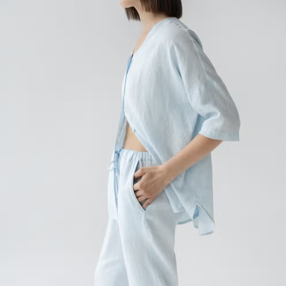 A stylish baby blue linen loungewear set featuring a loose-fit shirt and comfortable pants, perfect for relaxation and casual wear.