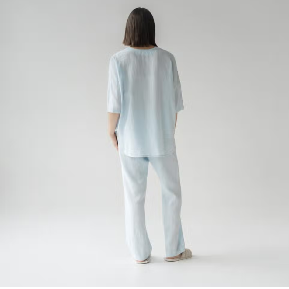 A stylish baby blue linen loungewear set featuring a loose-fit shirt and comfortable pants, perfect for relaxation and casual wear.