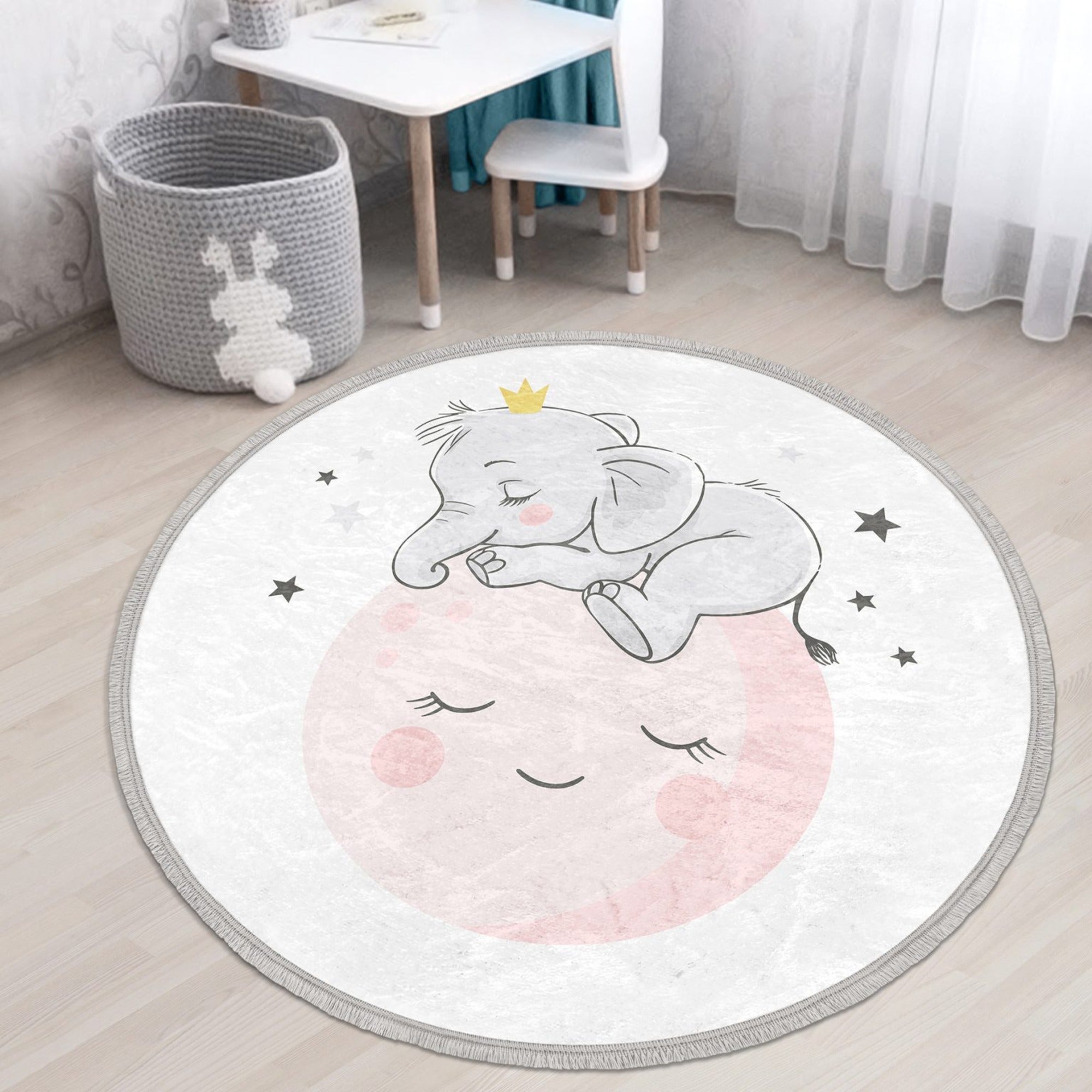 Round rug featuring a baby elephant and moon print, designed for kids' rooms, made of shiny velvet fabric with fringes.