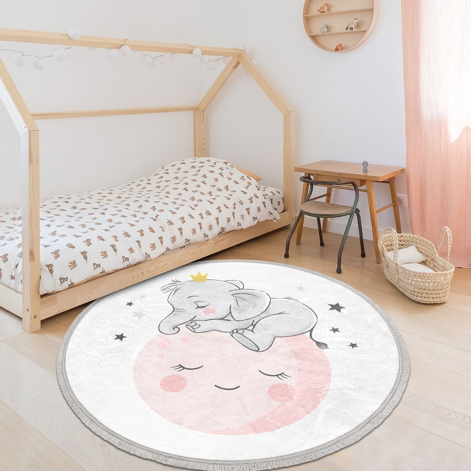 Round rug featuring a baby elephant and moon print, designed for kids' rooms, made of shiny velvet fabric with fringes.