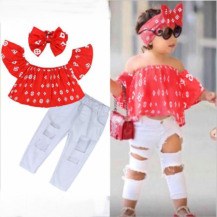 A stylish two-piece summer outfit for baby girls, featuring an off-shoulder top, trendy hole pants, and a matching headband.