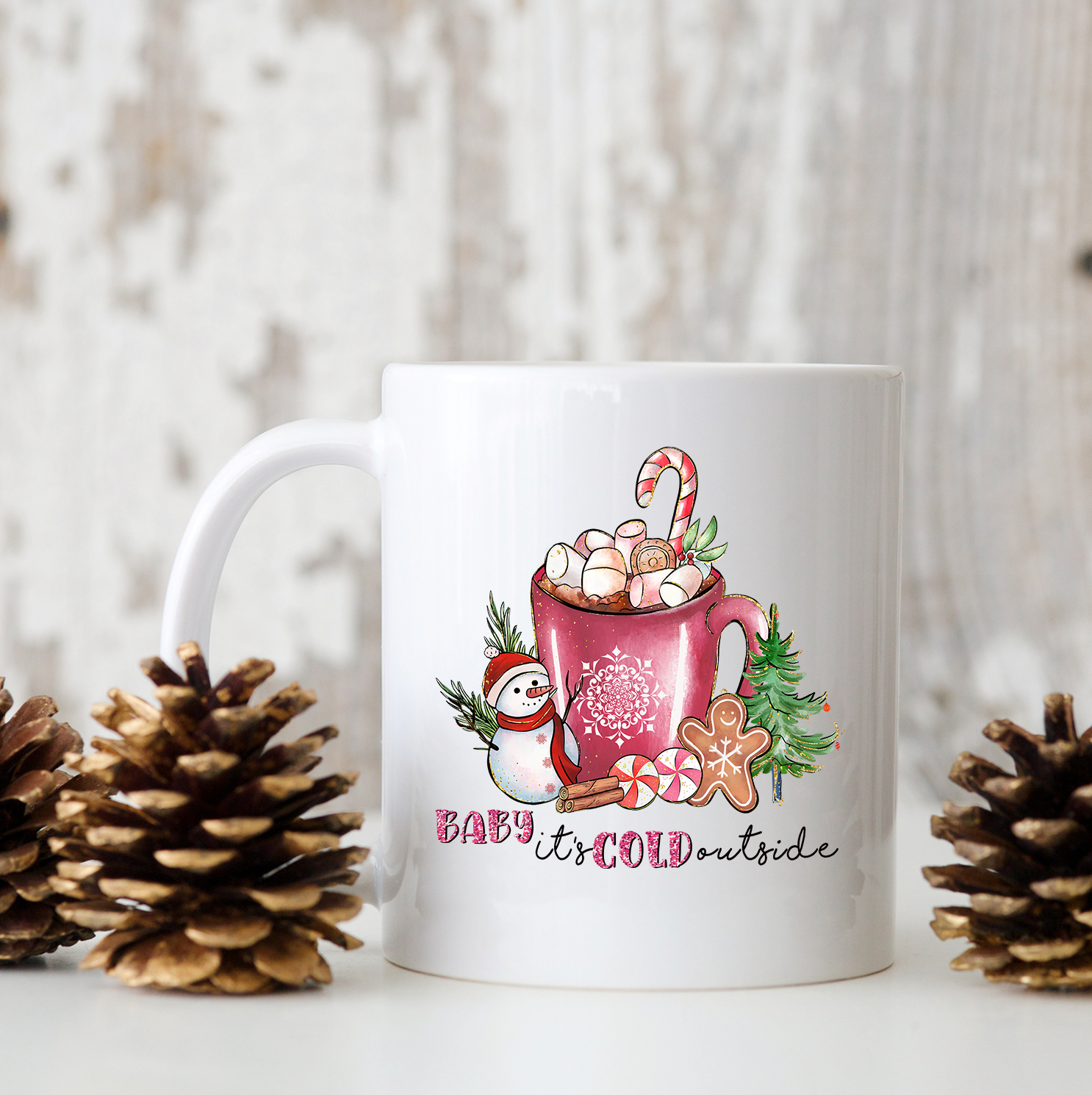 A glossy white ceramic mug with the phrase 'Baby It's Cold Outside' printed in vibrant colors, perfect for coffee or tea.