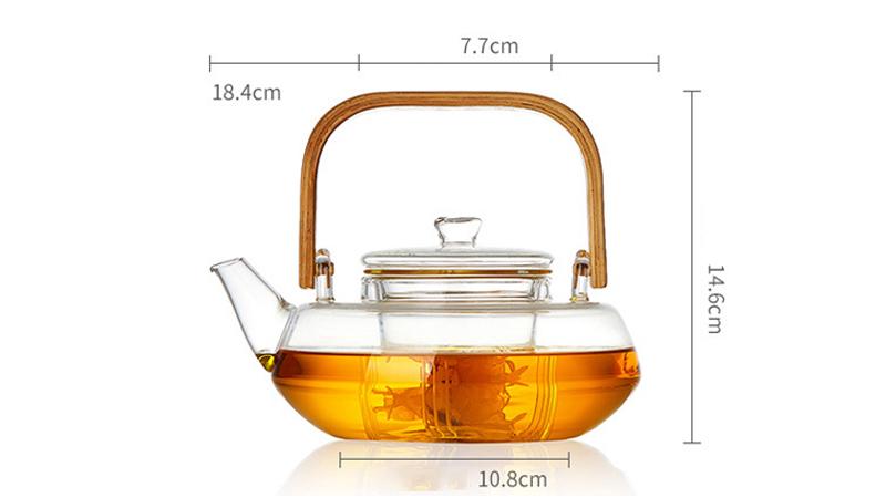 A stylish Bamboo & Glass Tea Kettle featuring an ergonomic handle and removable infuser, perfect for brewing loose-leaf tea.