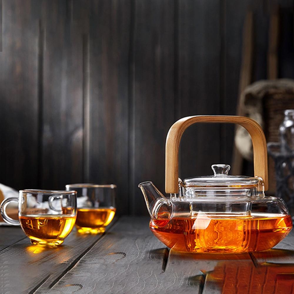 A stylish Bamboo & Glass Tea Kettle featuring an ergonomic handle and removable infuser, perfect for brewing loose-leaf tea.