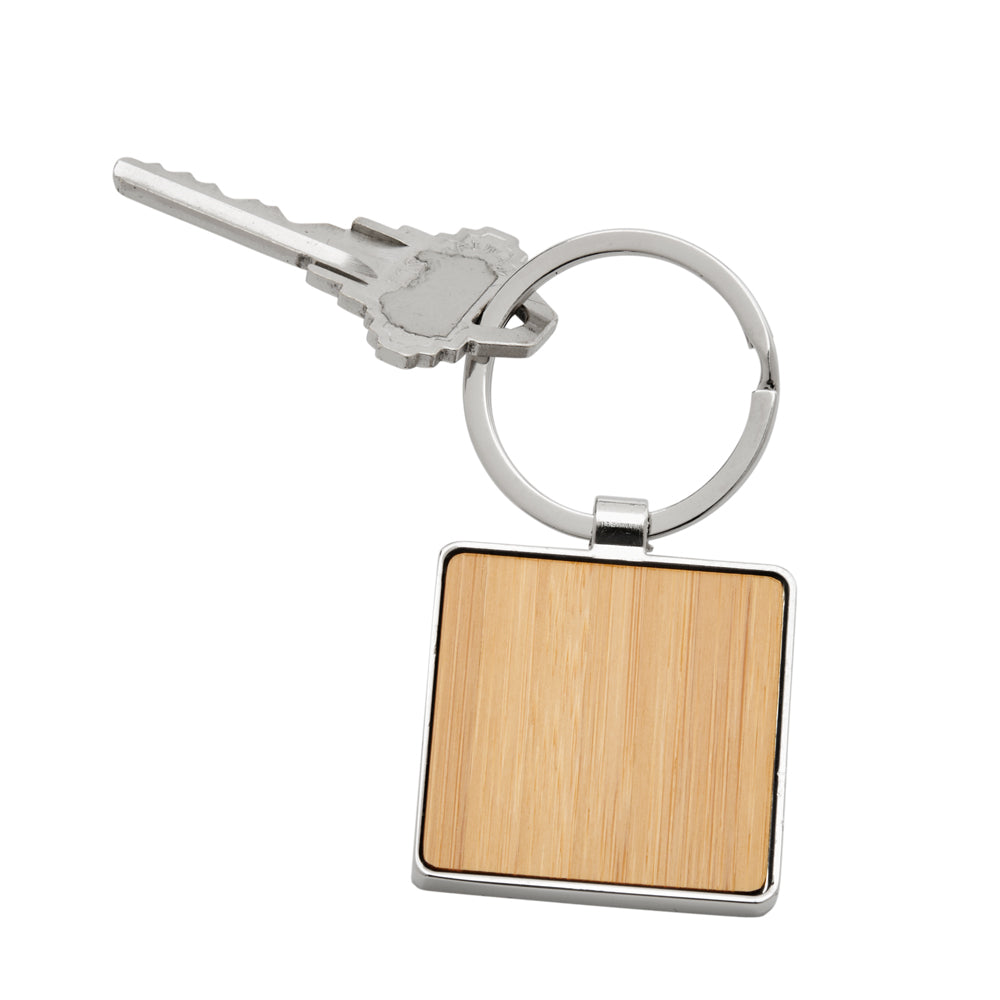 Bamboo Square Keychain with intricate metal trim, showcasing its sustainable design and elegant packaging.