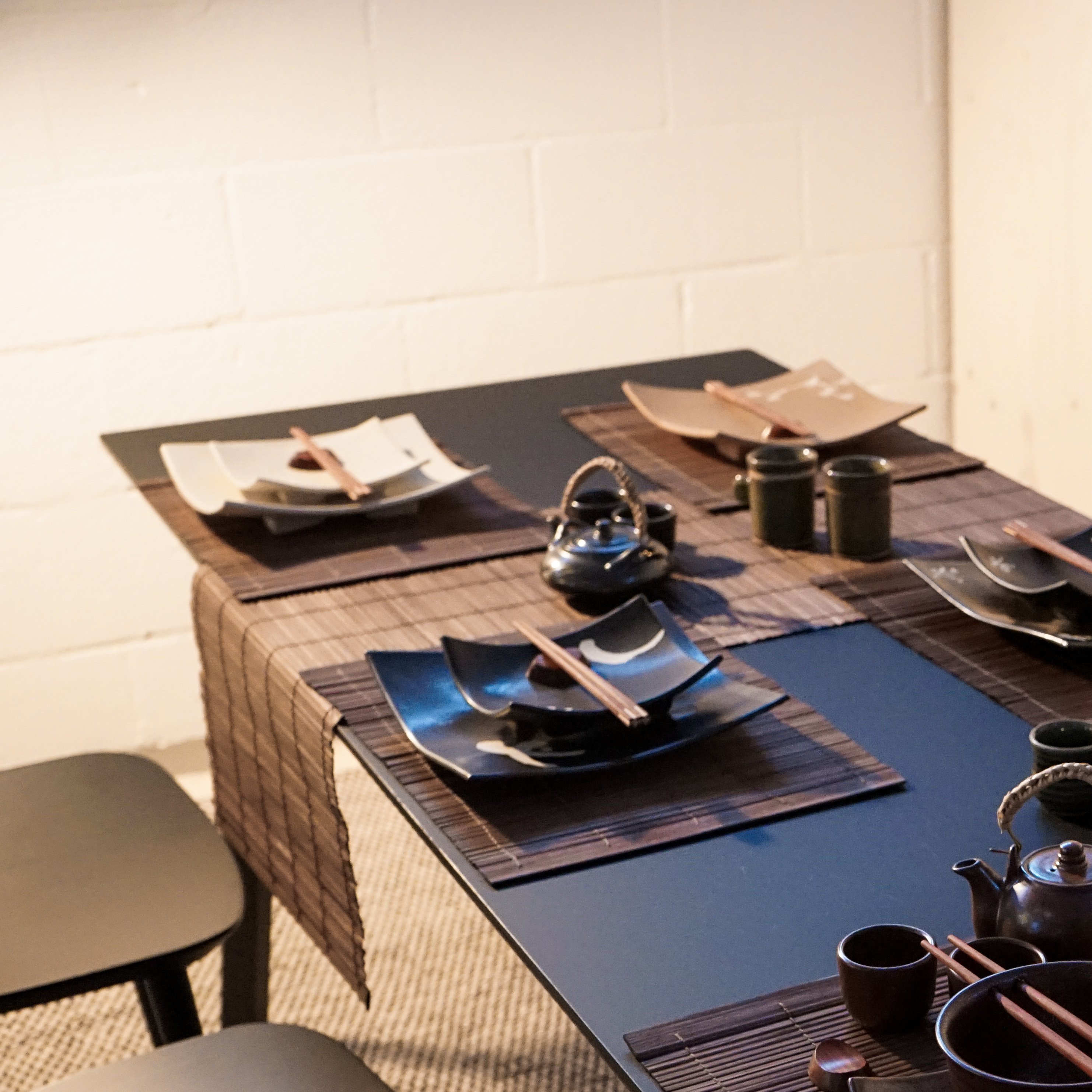 A beautifully handcrafted bamboo table runner in rich brown color, elegantly draped over a dining table, showcasing its natural texture and design.