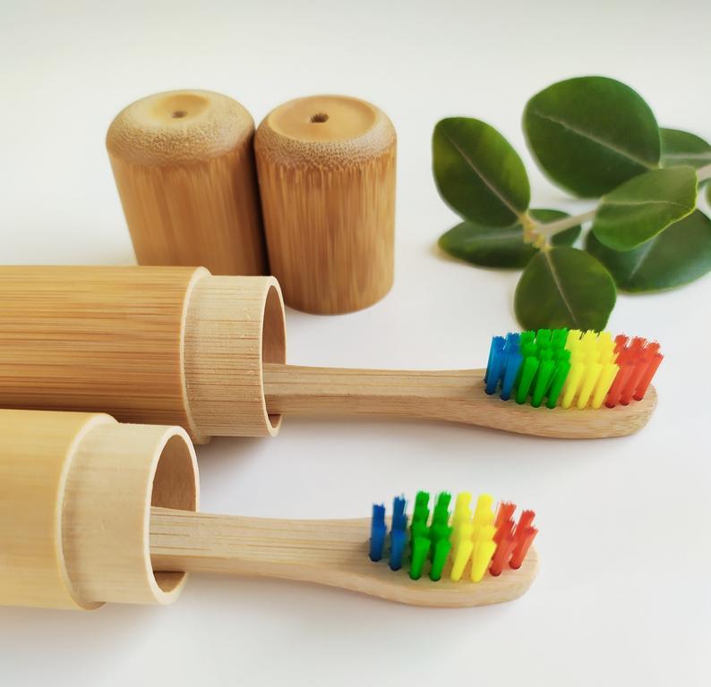 A sustainable bamboo toothbrush case, lightweight and eco-friendly, designed to hold a bamboo toothbrush securely.