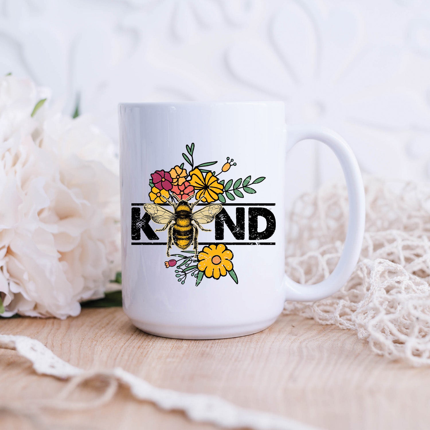 Bee Kind Wildflower 15oz Mug featuring a vibrant wildflower design on a glossy white ceramic surface.