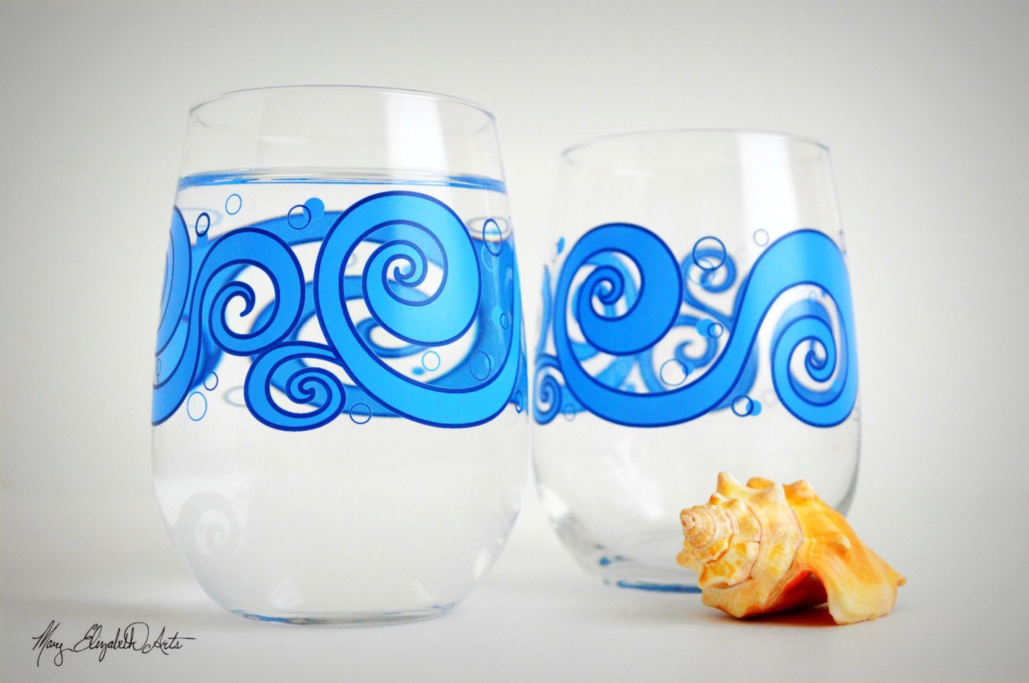 Beach Theme 3 Piece Gift Set featuring two ocean waves stemless wine glasses and an Ocean Breeze greeting card, beautifully arranged.