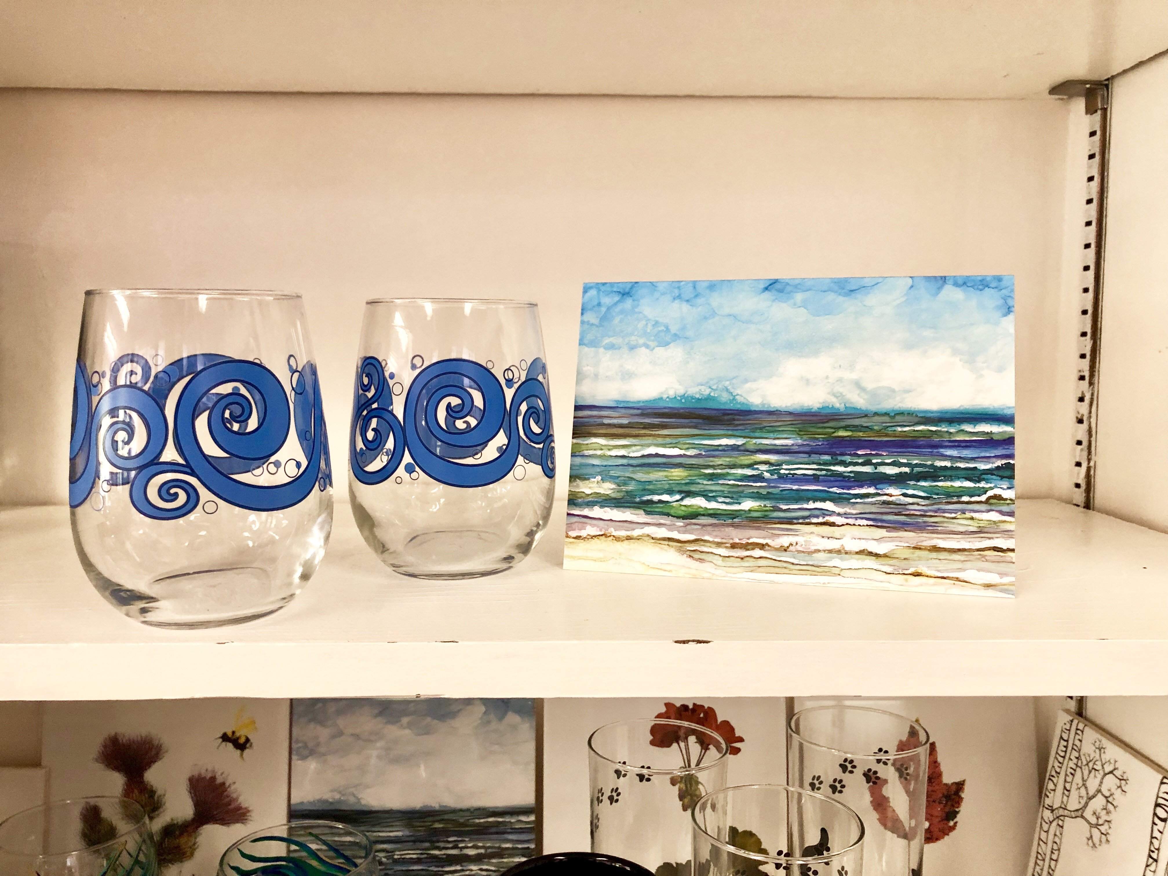 Beach Theme 3 Piece Gift Set featuring two ocean waves stemless wine glasses and an Ocean Breeze greeting card, beautifully arranged.