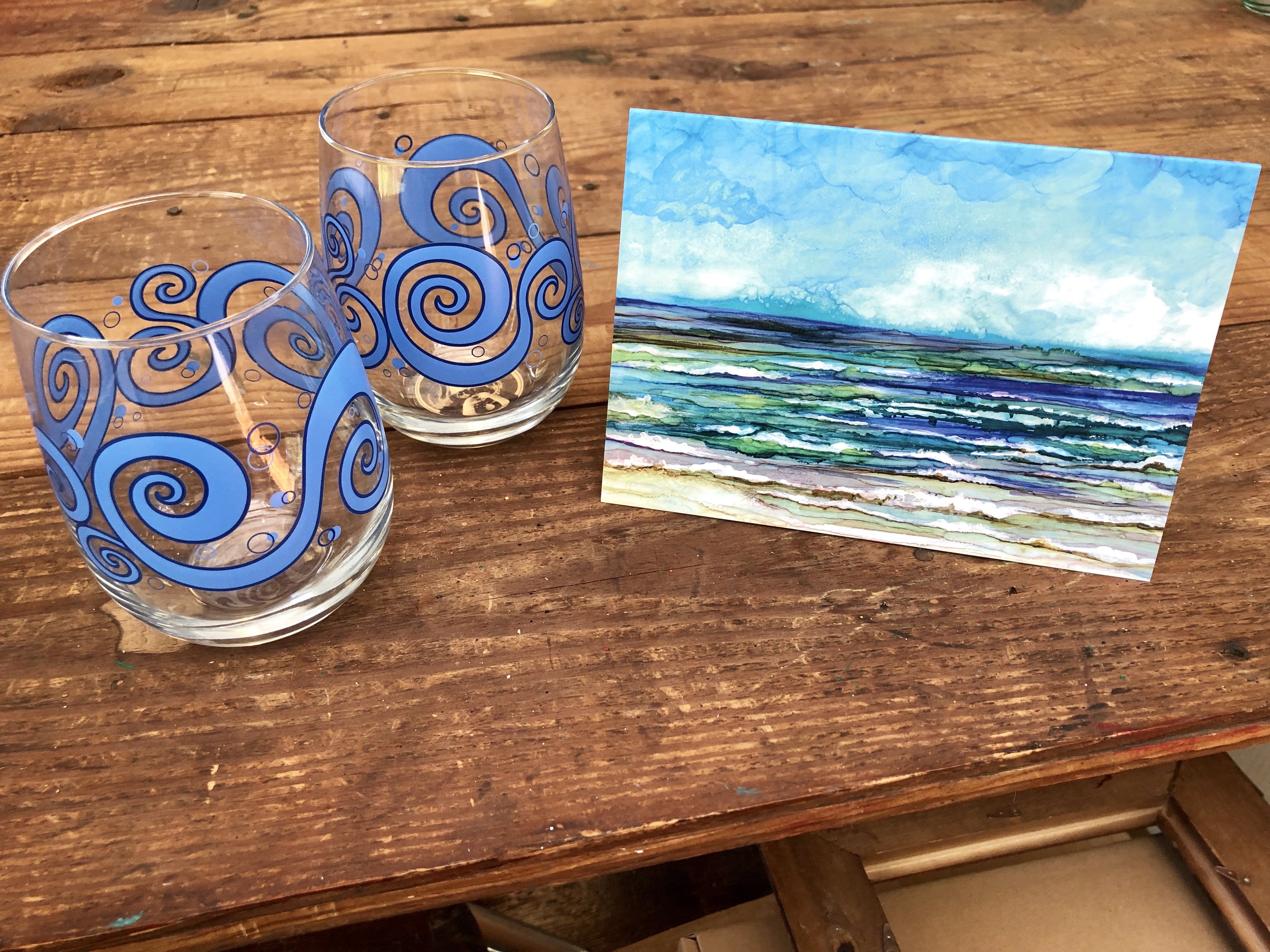 Beach Theme 3 Piece Gift Set featuring two ocean waves stemless wine glasses and an Ocean Breeze greeting card, beautifully arranged.