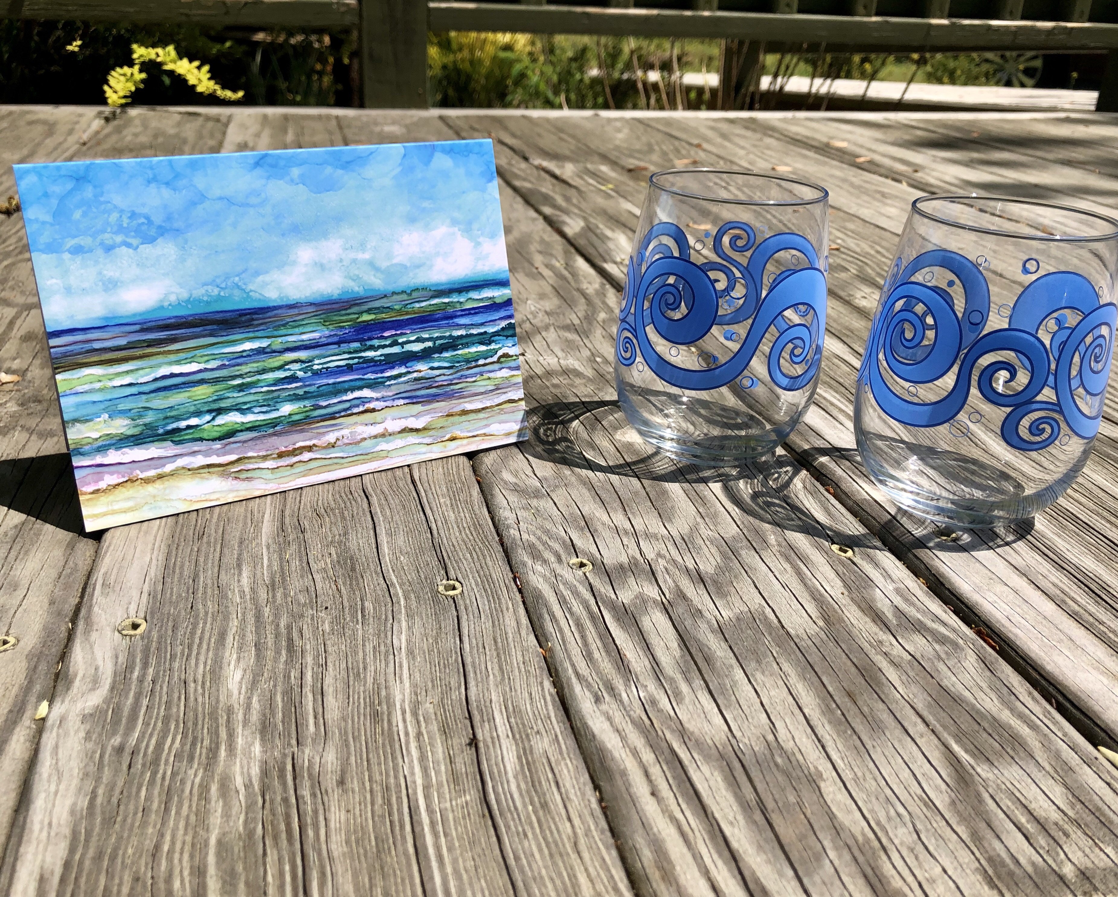 Beach Theme 3 Piece Gift Set featuring two ocean waves stemless wine glasses and an Ocean Breeze greeting card, beautifully arranged.