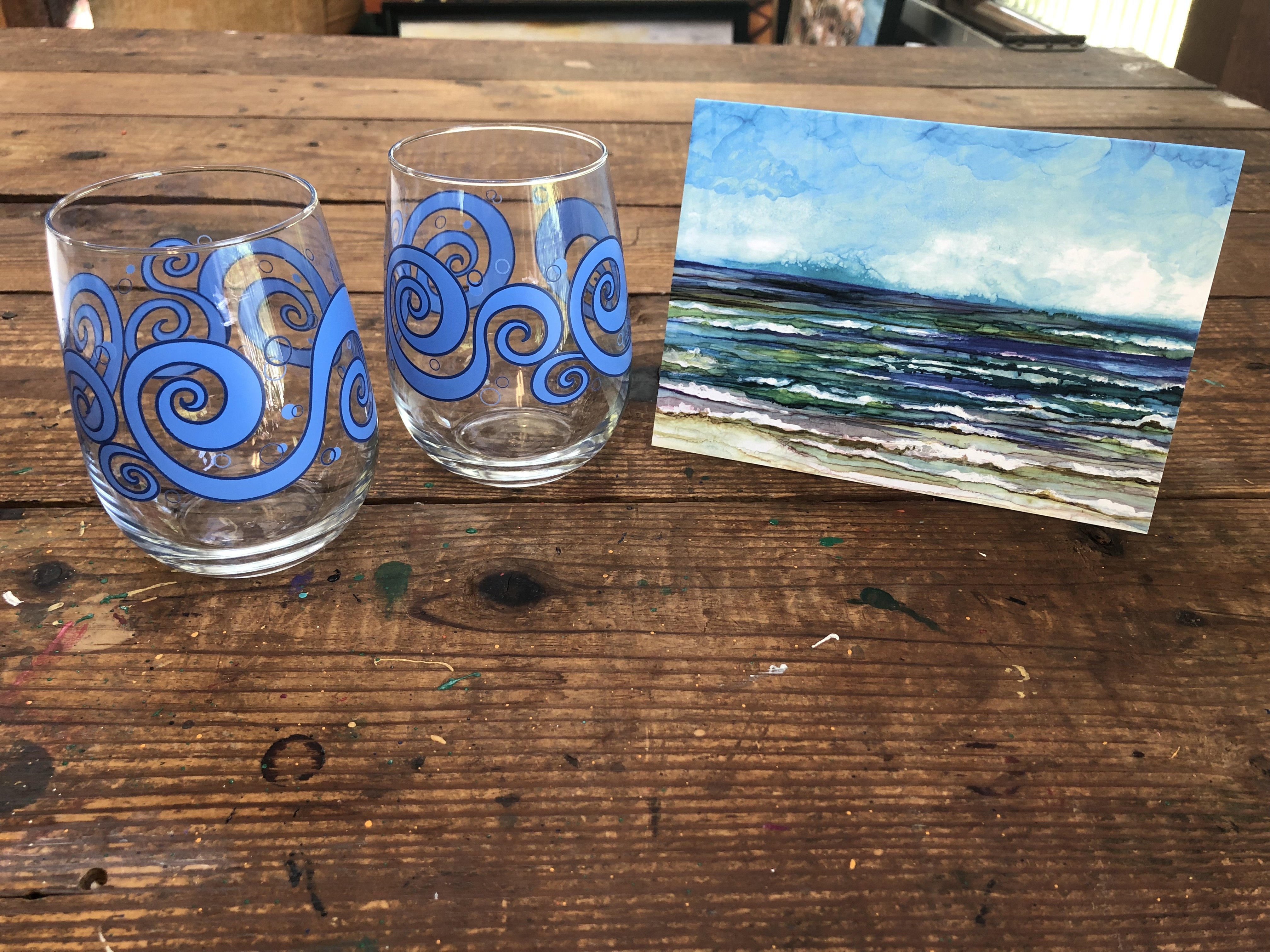 Beach Theme 3 Piece Gift Set featuring two ocean waves stemless wine glasses and an Ocean Breeze greeting card, beautifully arranged.