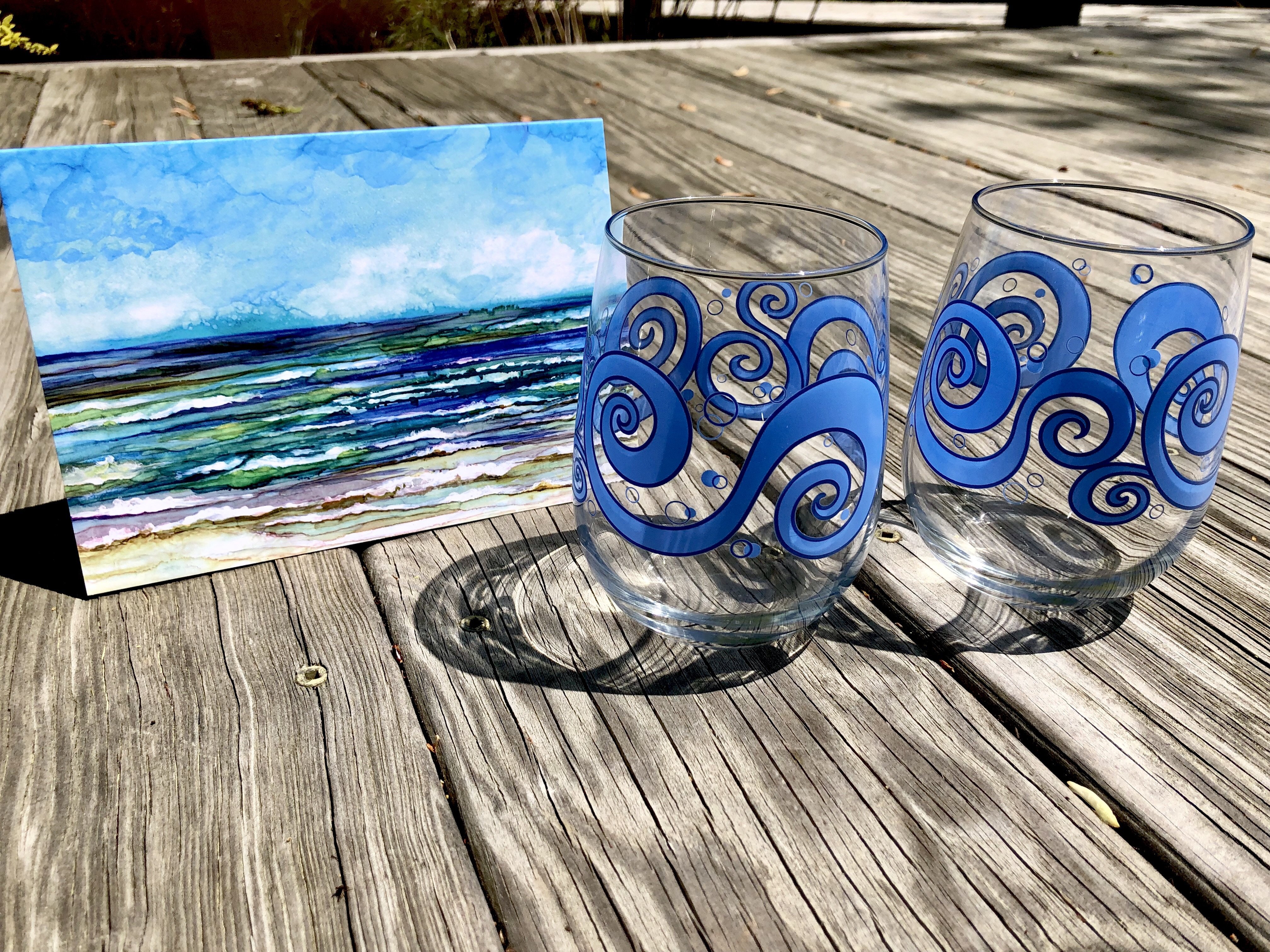 Beach Theme 3 Piece Gift Set featuring two ocean waves stemless wine glasses and an Ocean Breeze greeting card, beautifully arranged.