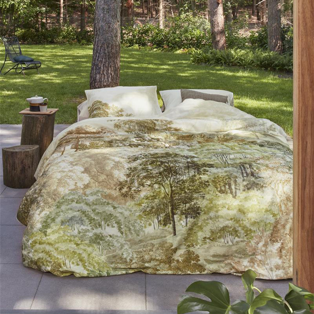 Bedding House Arcadia Green Cotton Sateen Quilt Cover Set featuring a landscape print with hand-painted trees in natural hues.