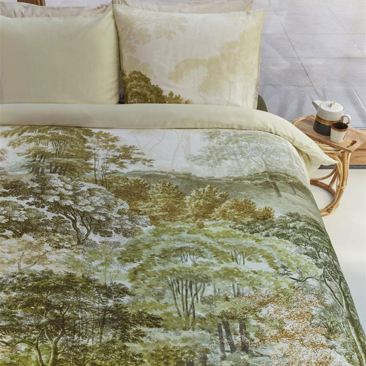 Bedding House Arcadia Green Cotton Sateen Quilt Cover Set featuring a landscape print with hand-painted trees in natural hues.