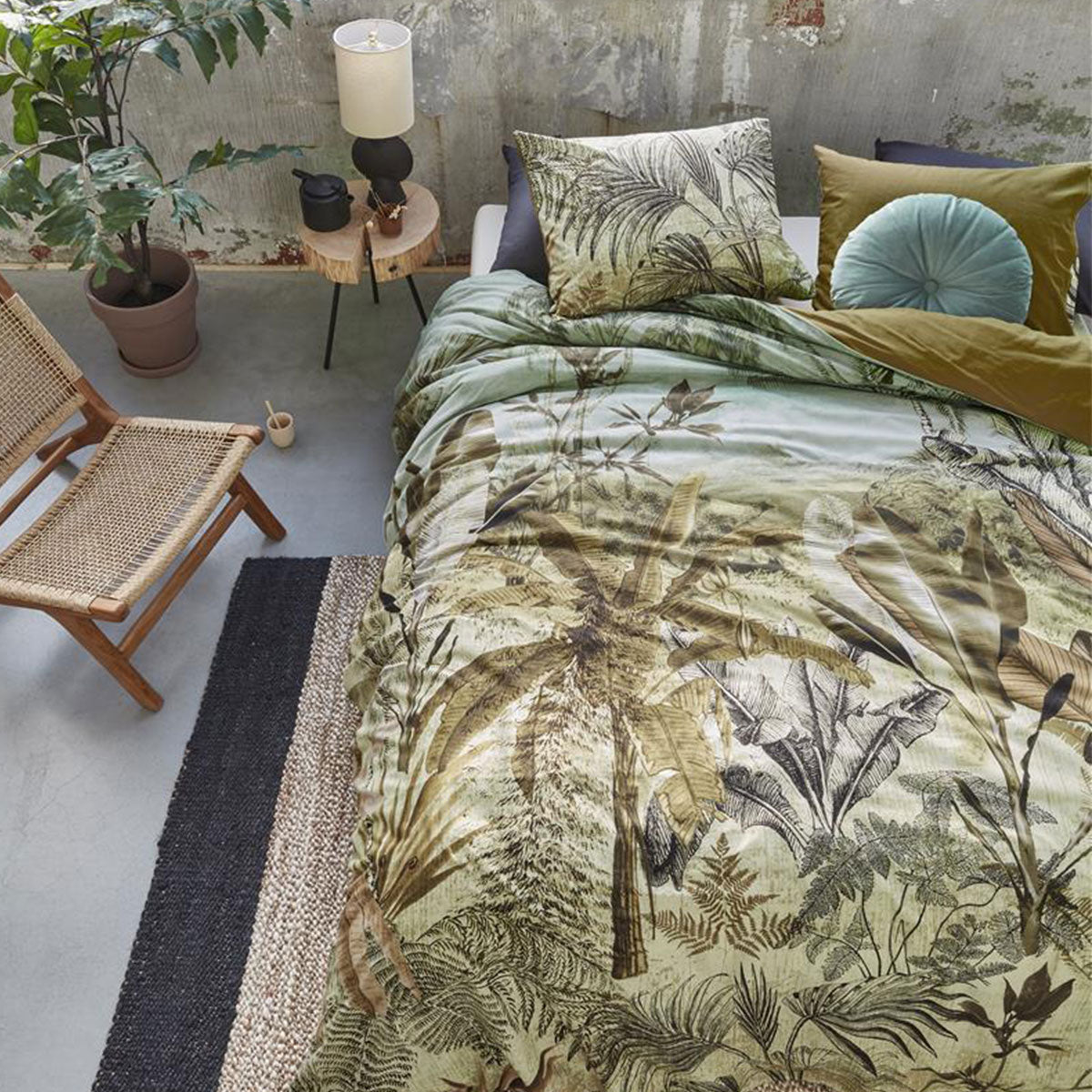 Banda Green Cotton Quilt Cover Set featuring banana leaves and palm trees design in natural tones on a calming background.