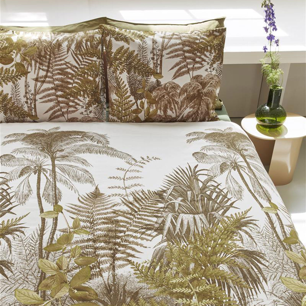 Bedding House Caribe Ochre Cotton Quilt Cover Set featuring tropical palm tree and fern designs in warm ochre and olive tones.