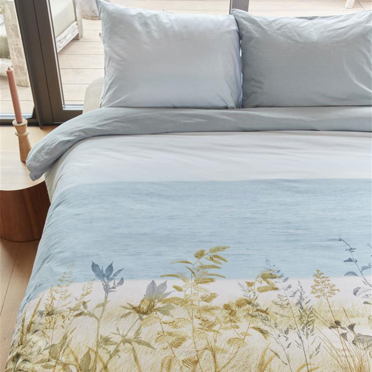 Bedding House Dunes Natural Cotton Quilt Cover Set featuring a summer seascape design with dunes, grasses, and flowers in natural colors.