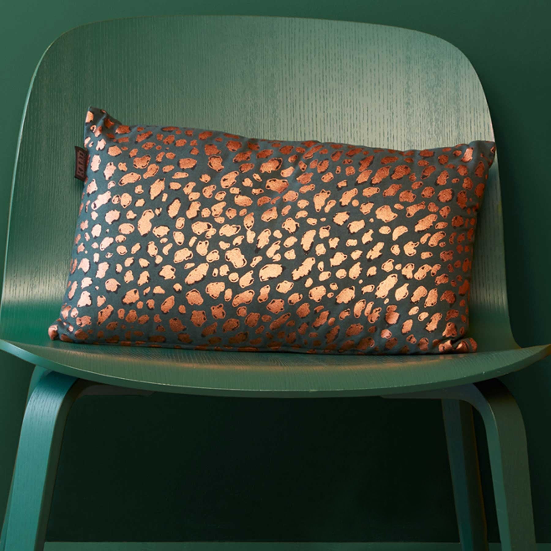 Bedding House Felidea Green Filled Oblong Cushion featuring an animal skin print design in vibrant colors, made from soft cotton fabric.