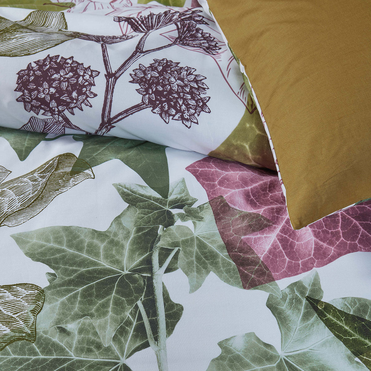 Ivy Multi Cotton Quilt Cover Set featuring vibrant ivy leaves on a light background with olive green reverse side.