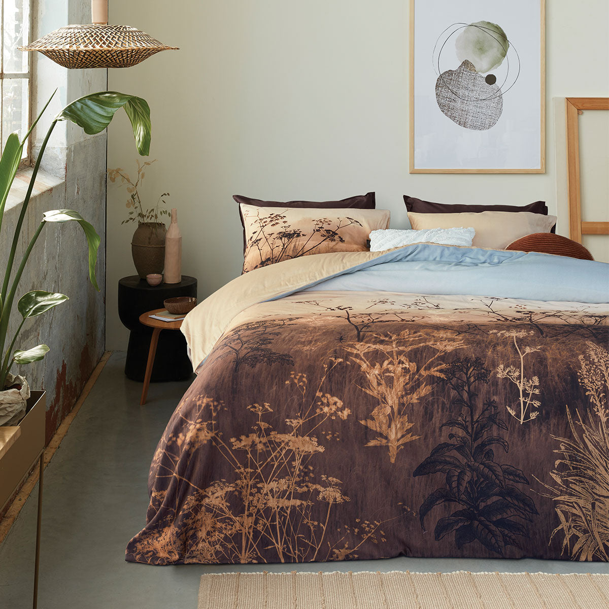 Bedding House Judy Brown Cotton Quilt Cover Set featuring a wildflower landscape print in taupe, brown, and sky colors, with a solid sand back.