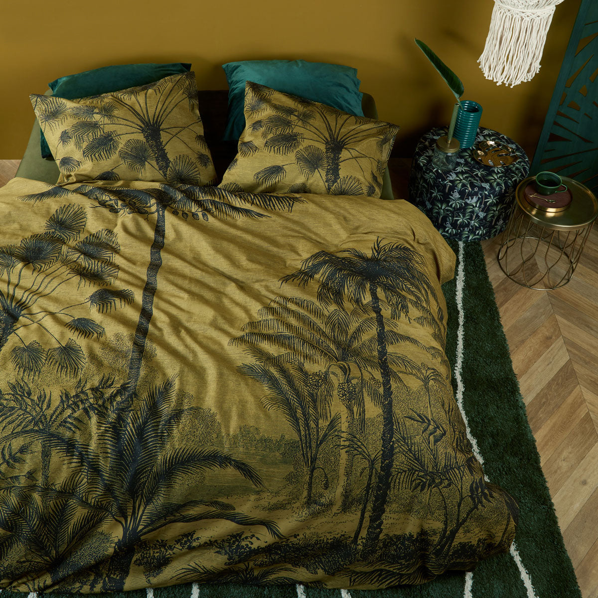 Tour du Monde Ochre Cotton Quilt Cover Set featuring a botanical landscape design with palms on a gold background.