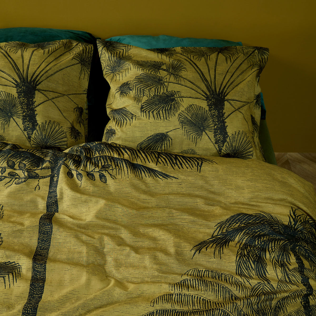 Tour du Monde Ochre Cotton Quilt Cover Set featuring a botanical landscape design with palms on a gold background.