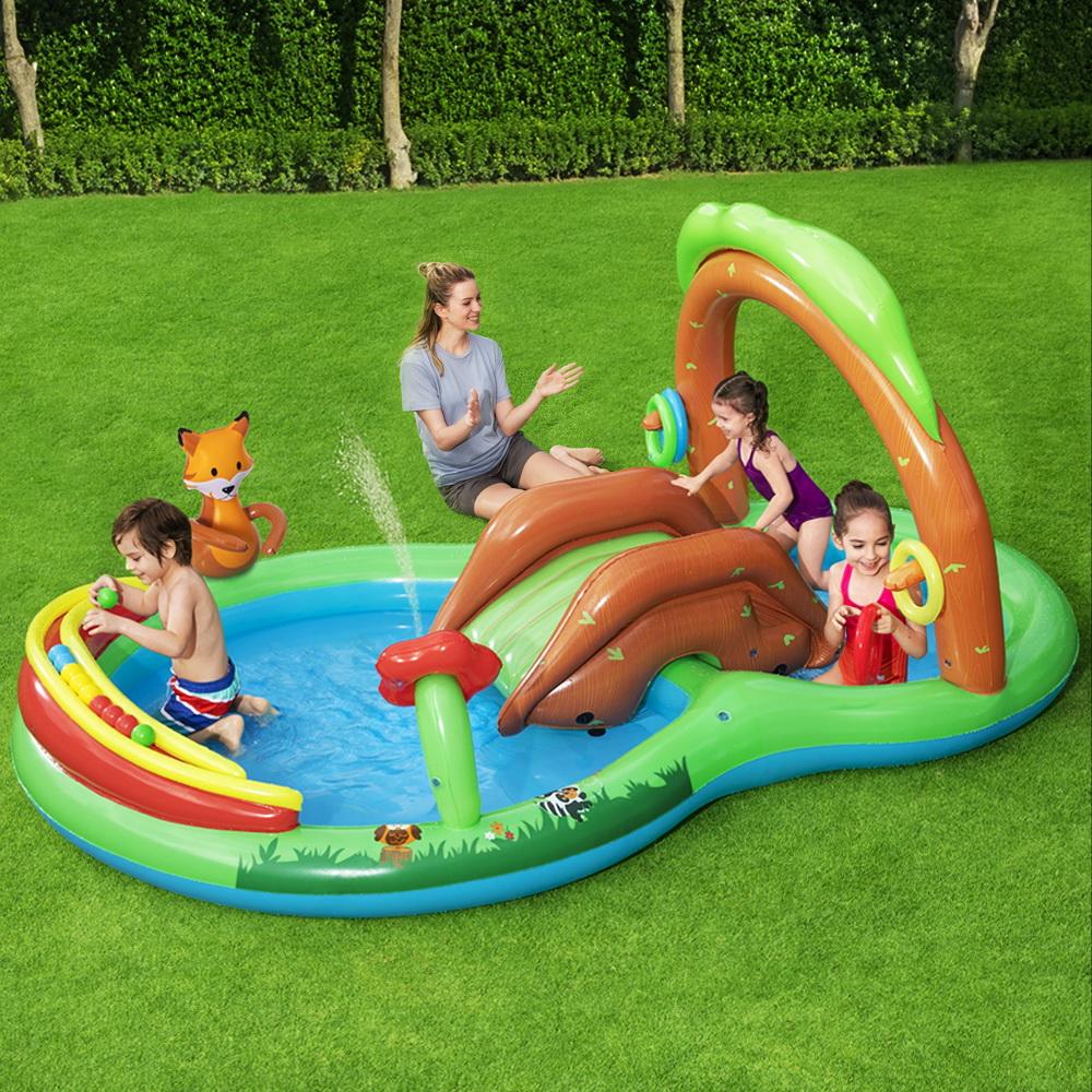 Bestway Swimming Pool Above Ground Inflatable for kids featuring a slide, water sprayer, and colorful play accessories in a backyard setting.