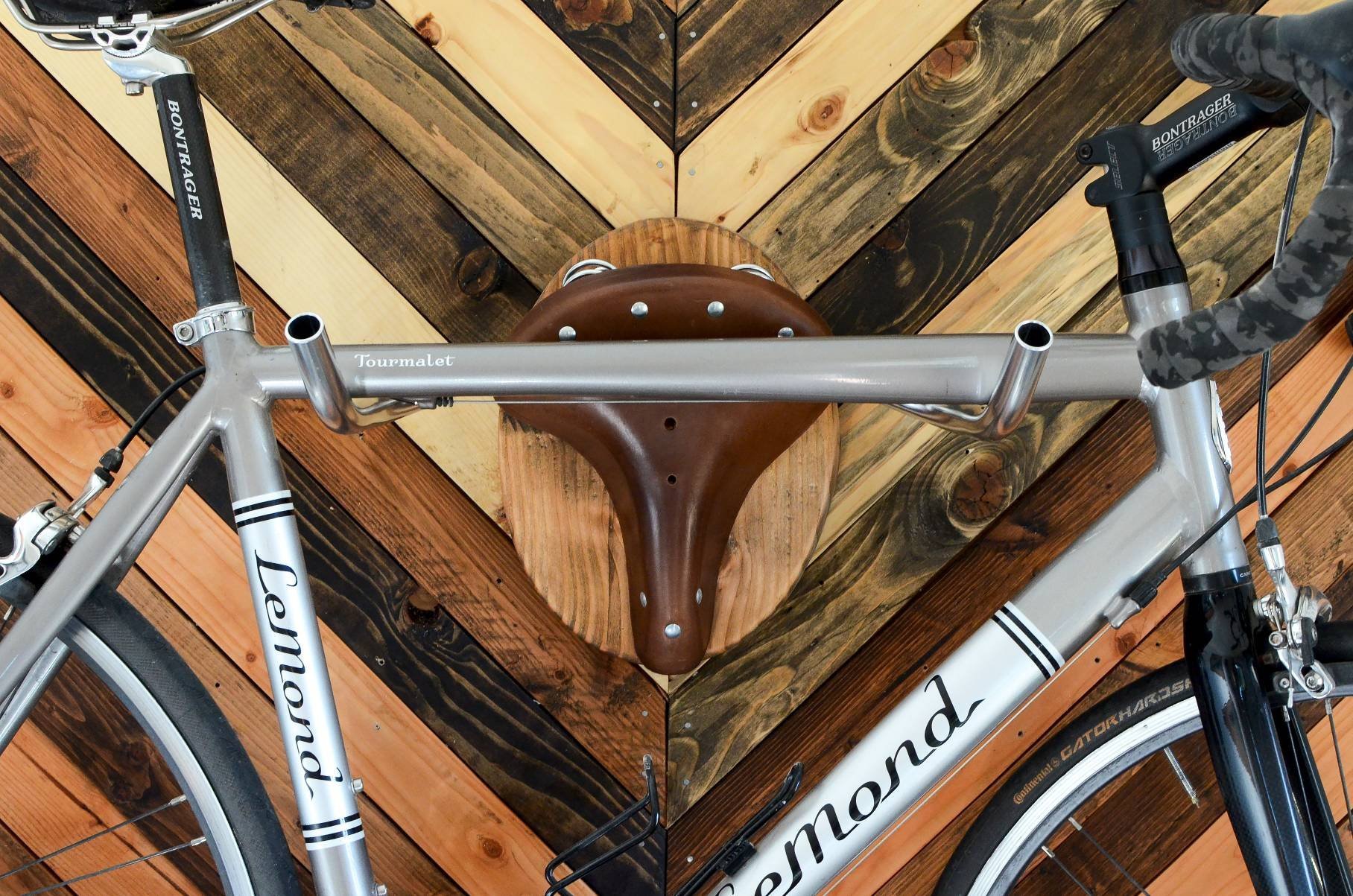 Bicycle Taxidermy Cycle Rack designed as an American Buffalo head, made from Oregon fir and leather, showcasing a bicycle.