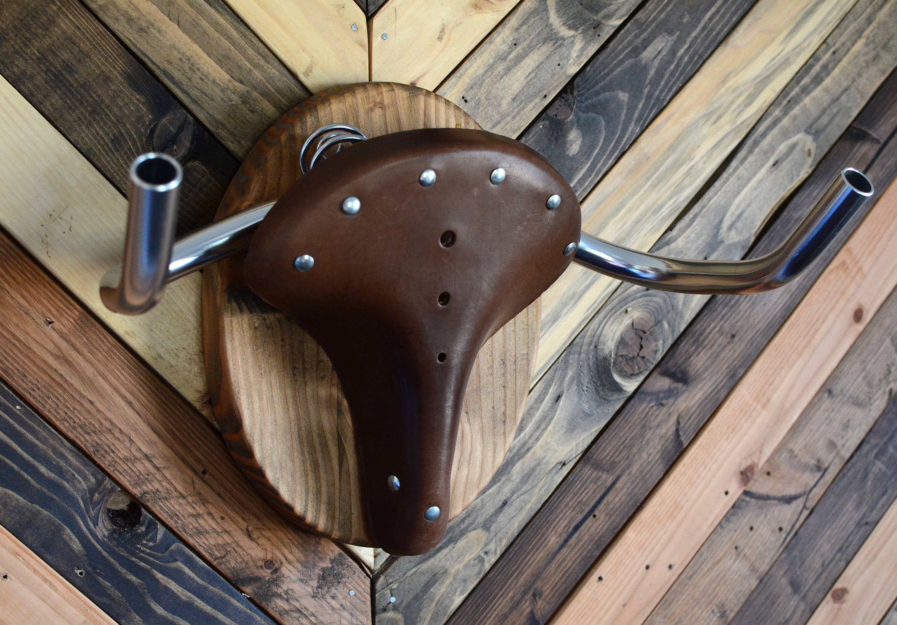 Bicycle Taxidermy Cycle Rack designed as an American Buffalo head, made from Oregon fir and leather, showcasing a bicycle.